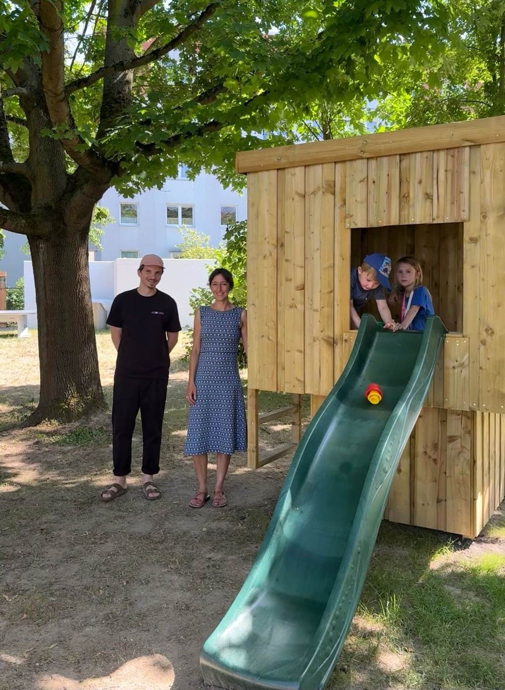 Kinder rutschen zum ersten Mal auf dem neuen Stelzenhaus